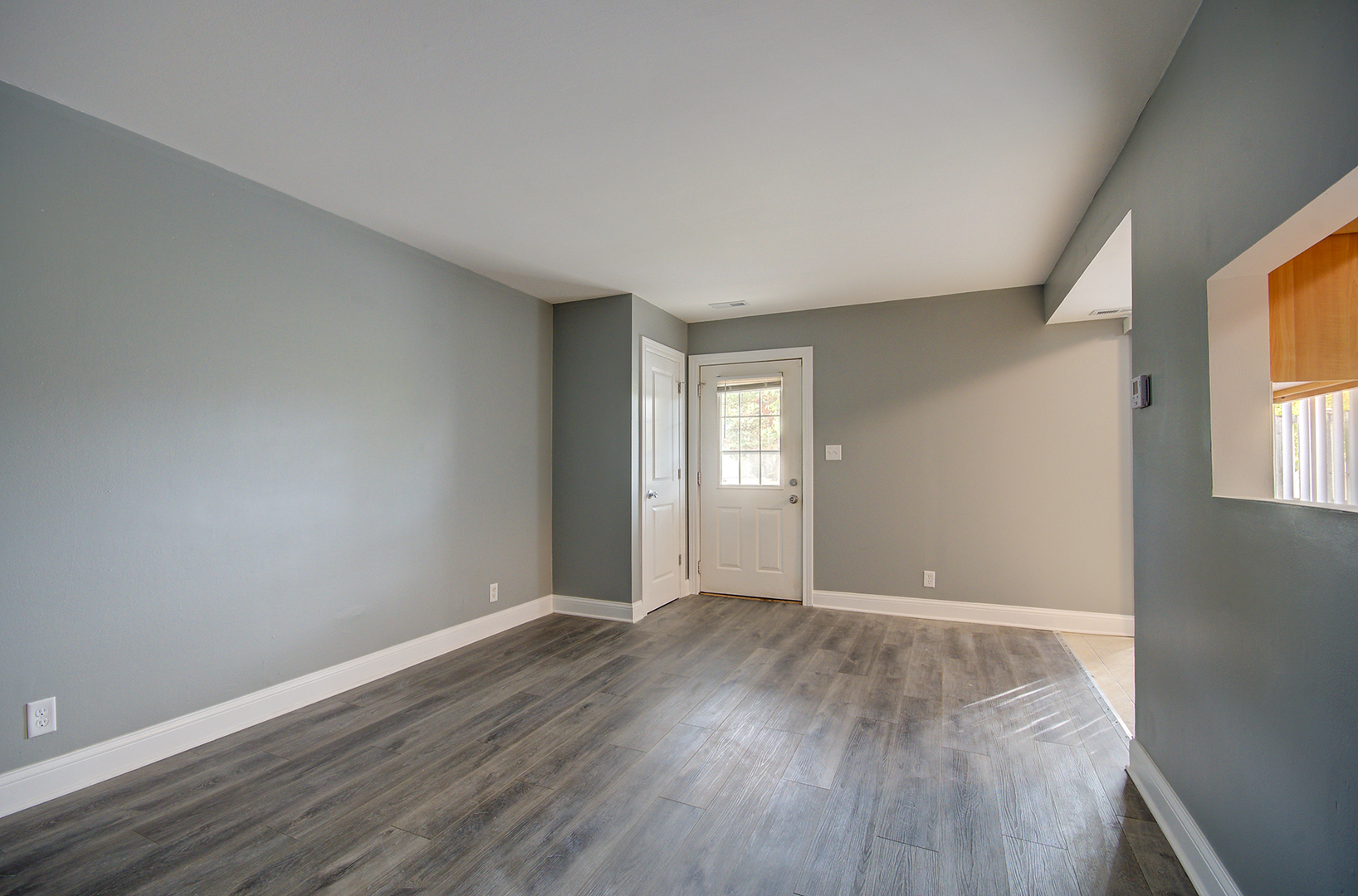2302 Carnation Drive, Unit 317C Crest Hill, IL 60403 - Photo 4 of 17 an empty room with wooden floor and windows