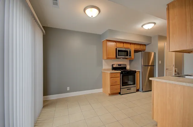 a kitchen with granite countertop a stove and a refrigerator