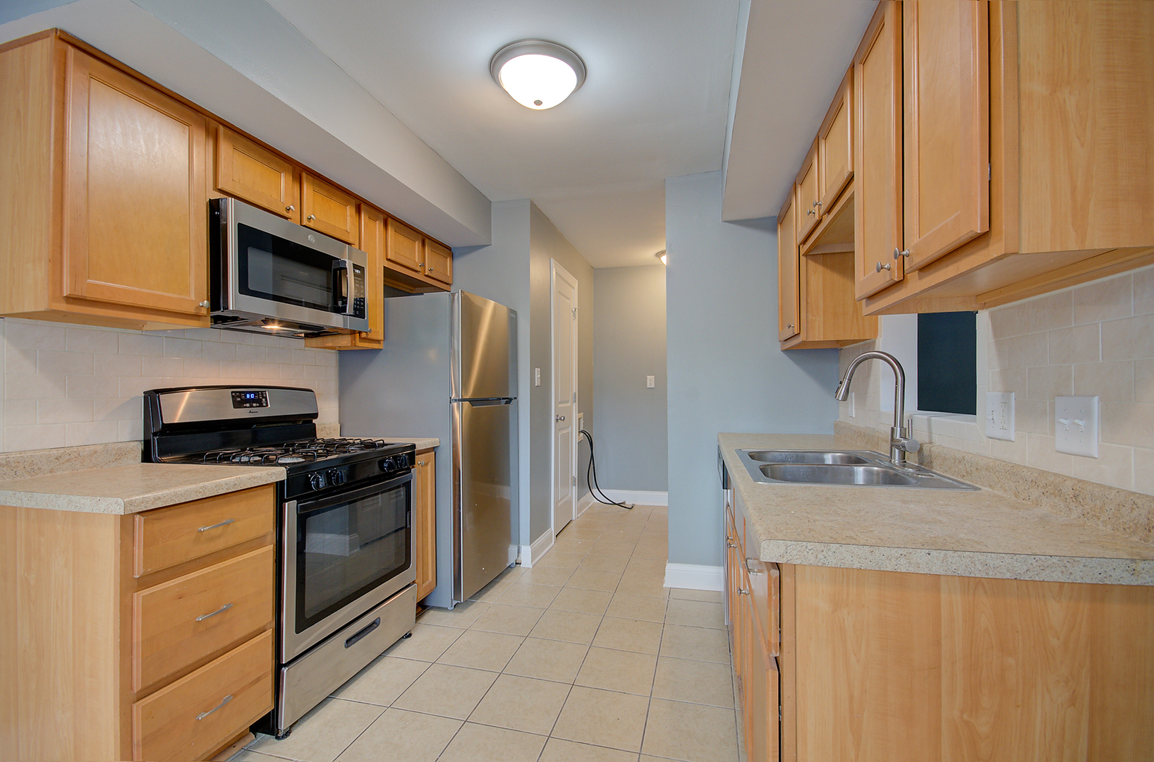 2302 Carnation Drive, Unit 317C Crest Hill, IL 60403 - Photo 6 of 17 a kitchen with stainless steel appliances granite countertop a refrigerator stove top oven a sink and dishwasher