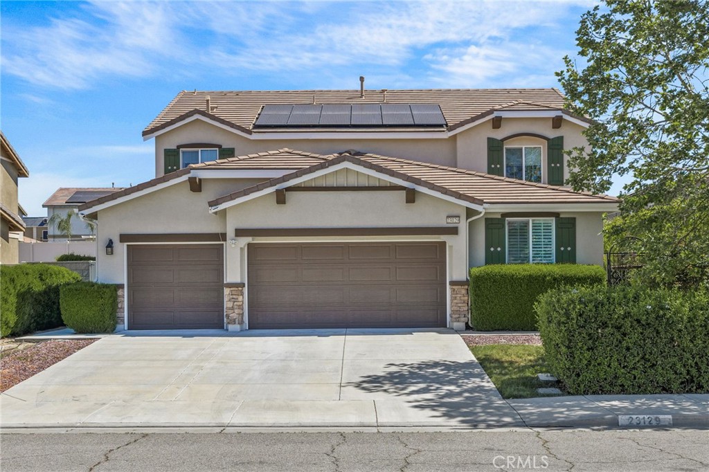 Beautifully maintained two-story home featuring great curb appeal, a spacious driveway, and a 3-car garage. The exterior showcases a modern neutral color palette with stone accents, manicured landscaping, and mature trees for added privacy. Equipped with solar panels for energy efficiency, this home offers both style and sustainability. Located in a well-kept neighborhood, this property is ideal for buyers seeking comfort, functionality, and long-term savings.
