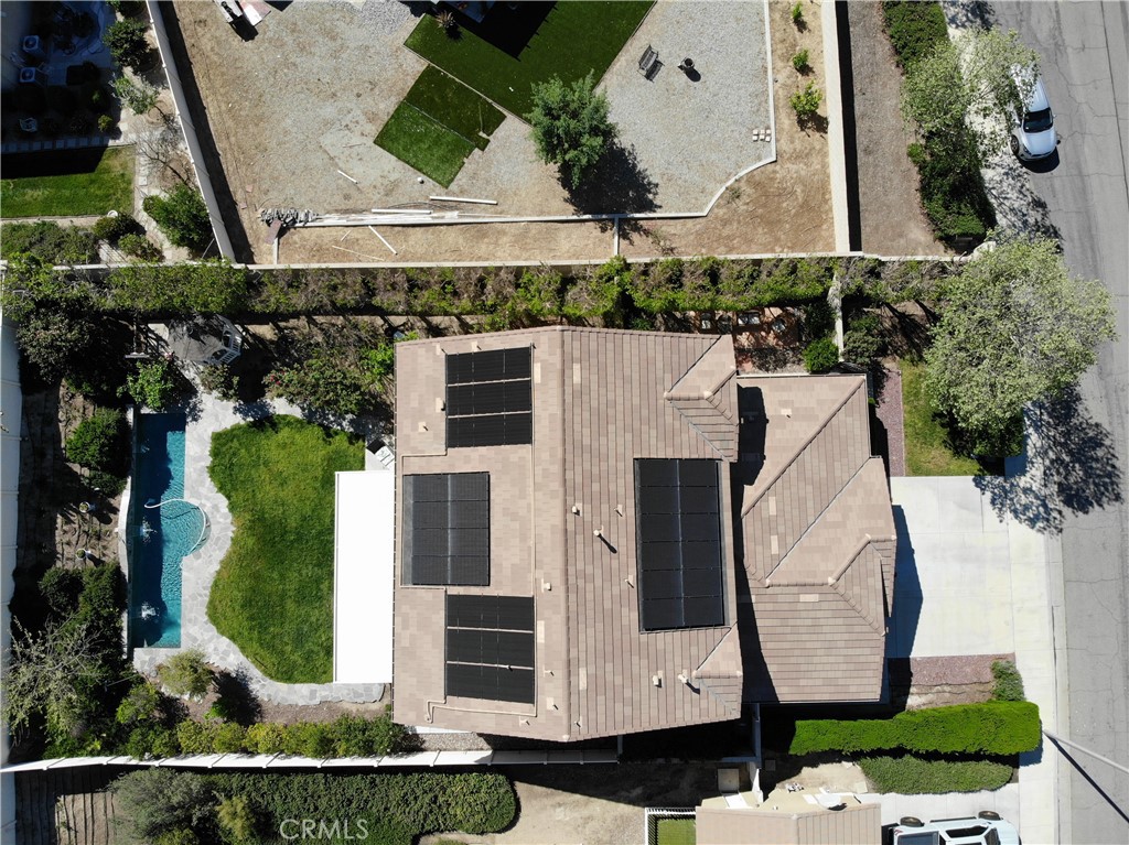 23129 Rustic Oak Drive Wildomar, CA 92595 - Photo 39 of 42 Resort-style backyard and energy-efficient upgrades highlight this impressive property. Enjoy a private pool and spa surrounded by lush landscaping, mature greenery, and multiple outdoor seating areas—perfect for entertaining or relaxing. The home is equipped with a fully installed solar system for enhanced efficiency and long-term savings. Situated on a well-sized lot with added privacy and functional outdoor space, this property offers the ideal blend of comfort, sustainability, and California outdoor ...