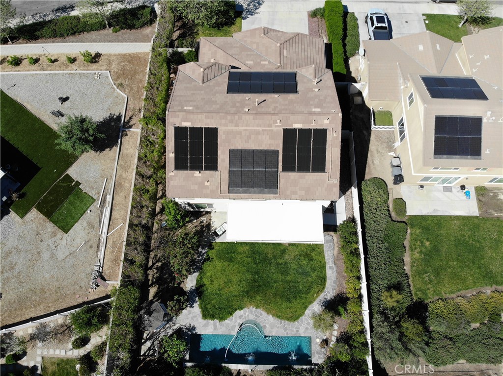 23129 Rustic Oak Drive Wildomar, CA 92595 - Photo 41 of 42 Resort-style backyard and energy-efficient upgrades highlight this impressive property. Enjoy a private pool and spa surrounded by lush landscaping, mature greenery, and multiple outdoor seating areas—perfect for entertaining or relaxing. The home is equipped with a fully installed solar system for enhanced efficiency and long-term savings. Situated on a well-sized lot with added privacy and functional outdoor space, this property offers the ideal blend of comfort, sustainability, and California outdoor ...