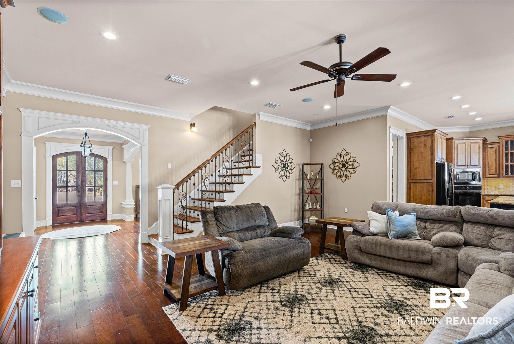 7676 Rockstone Lane Mobile, AL 36695 - Photo 7 of 47 Living area featuring arched walkways, french doors, crown molding, dark wood-style floors, and a ceiling fan