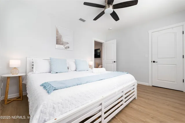 a bedroom with a bed and wooden floor