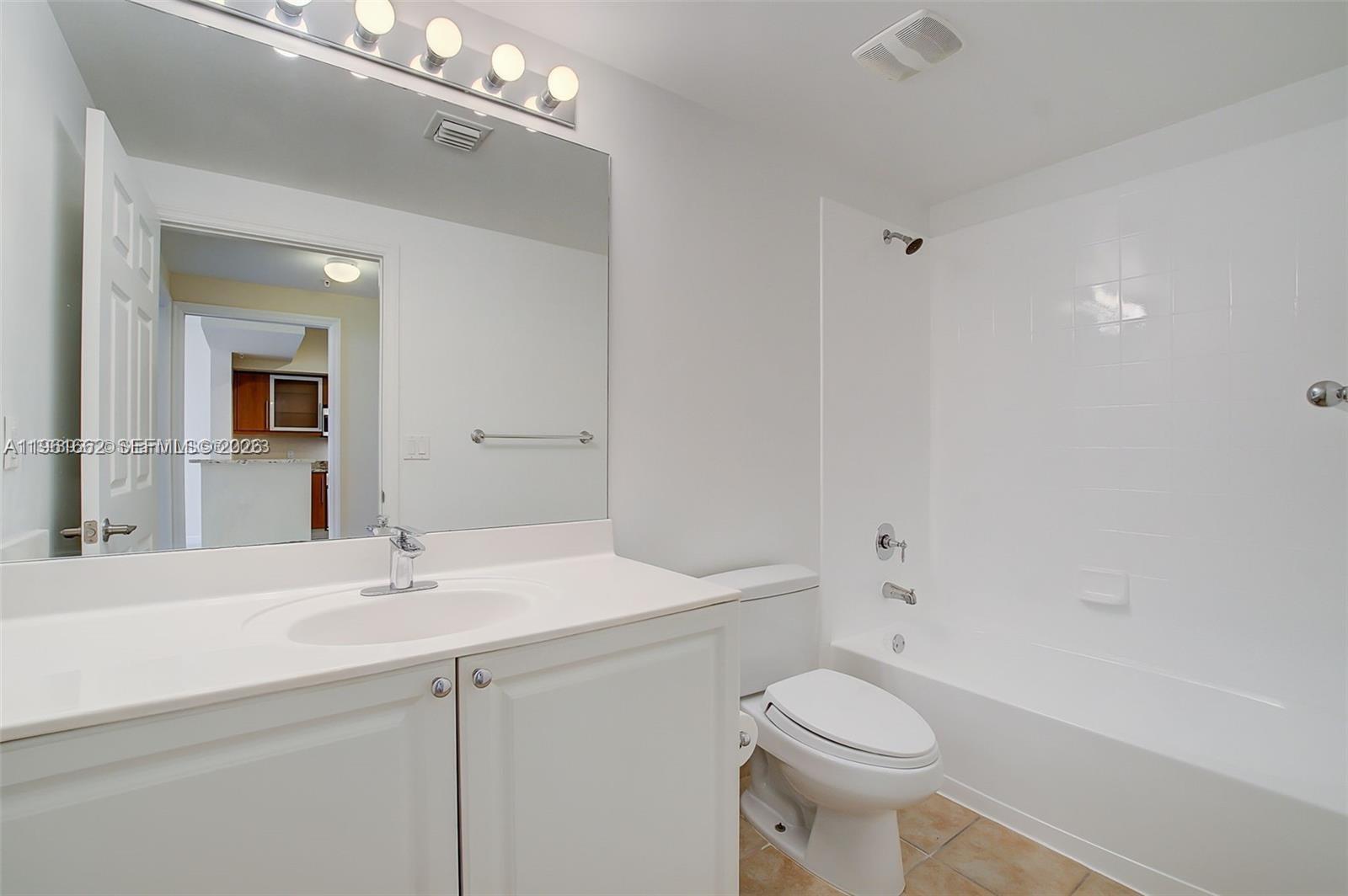 888 Douglas Road, Unit 1401 Coral Gables, FL 33134 - Photo 15 of 43 a bathroom with a sink a toilet and shower