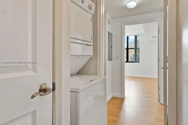 a view of a hallway with wooden floor and staircase
