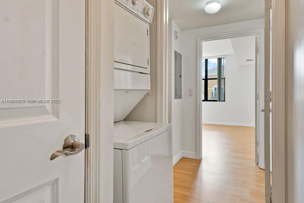 888 Douglas Road, Unit 1401 Coral Gables, FL 33134 - Photo 16 of 43 a view of a hallway with wooden floor and staircase