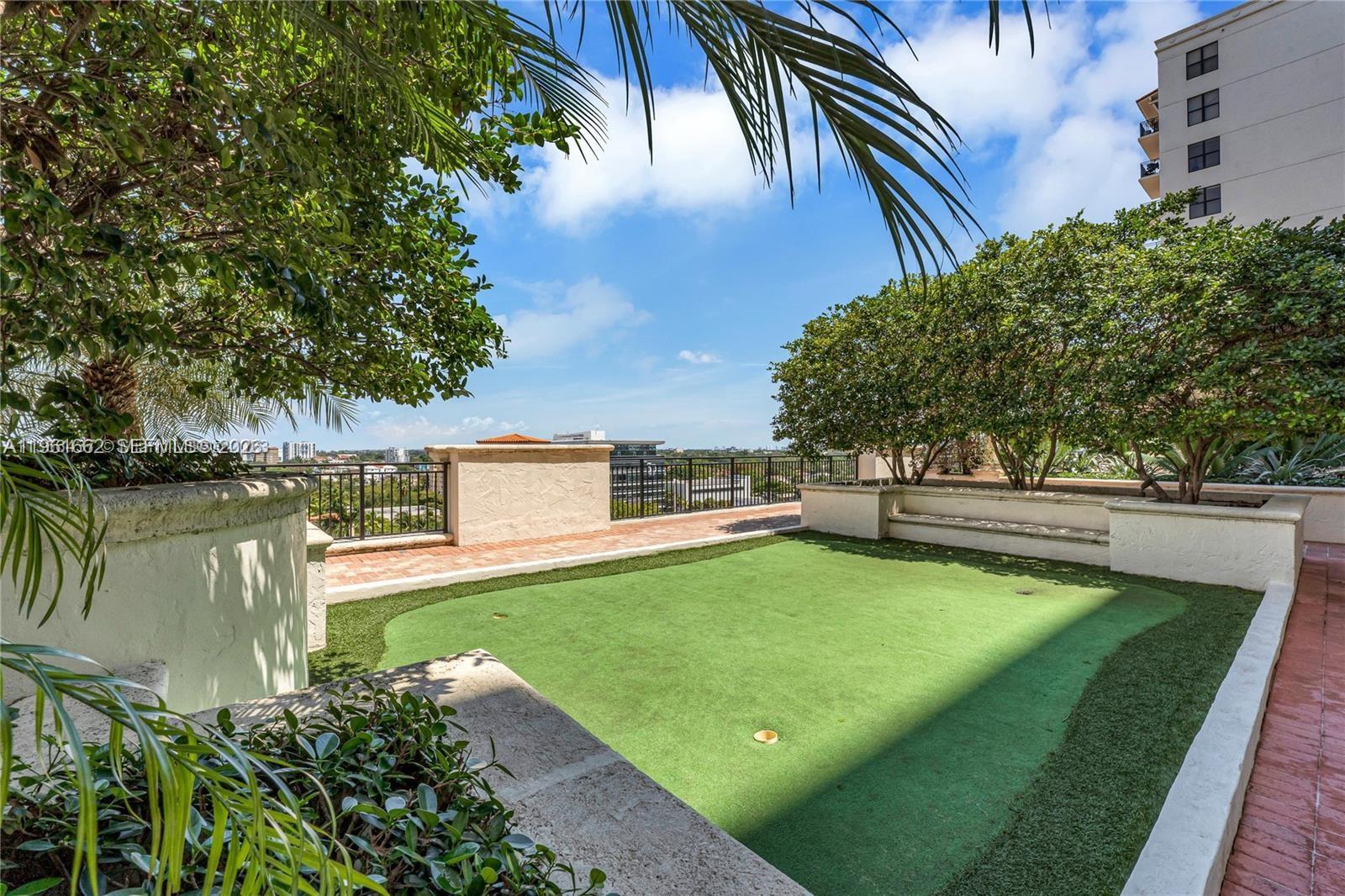 888 Douglas Road, Unit 1401 Coral Gables, FL 33134 - Photo 19 of 43 a view of a house with pool and a yard
