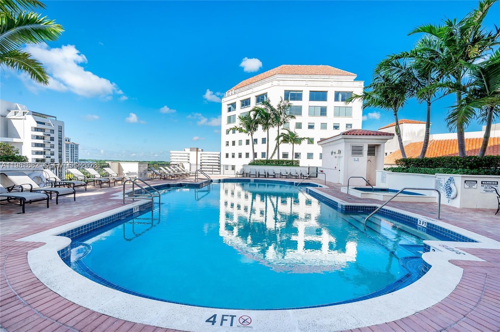 888 Douglas Road, Unit 1401 Coral Gables, FL 33134 - Photo 31 of 43 a view of a swimming pool with outdoor seating