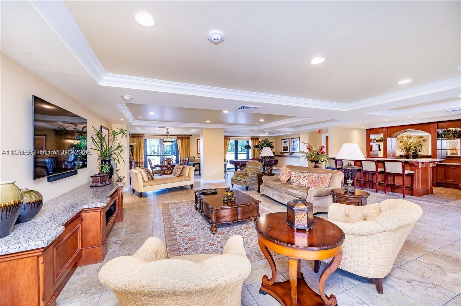 888 Douglas Road, Unit 1401 Coral Gables, FL 33134 - Photo 33 of 43 a living room with furniture a table and chairs