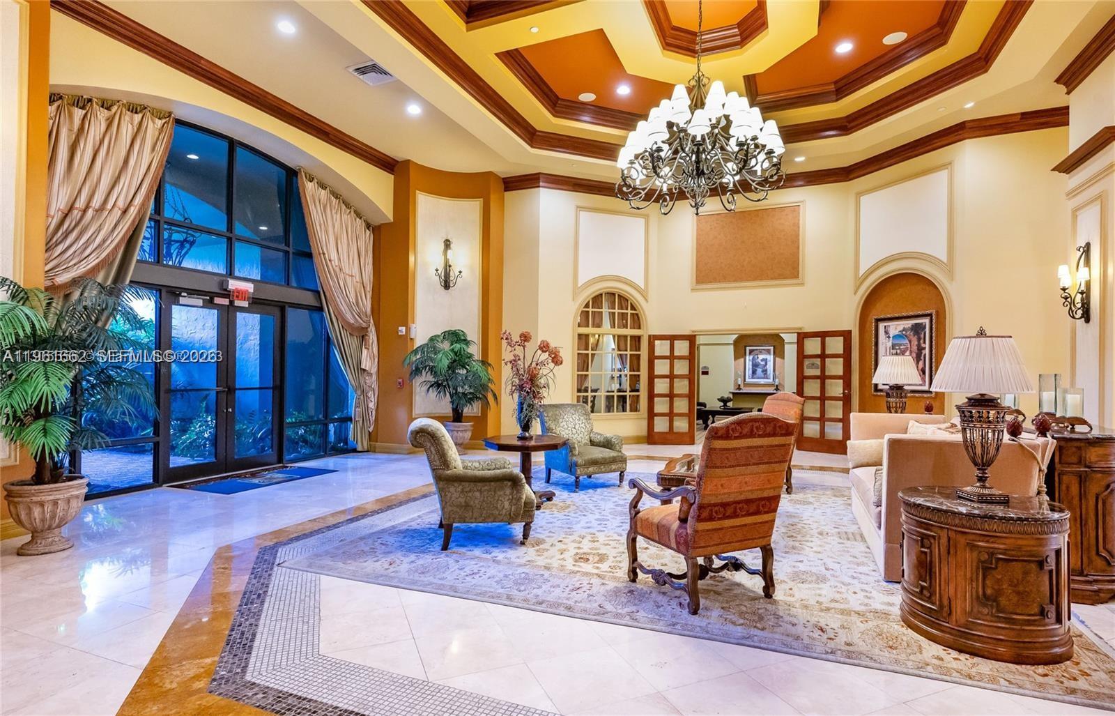 888 Douglas Road, Unit 1401 Coral Gables, FL 33134 - Photo 36 of 43 a living room with fireplace furniture and a chandelier