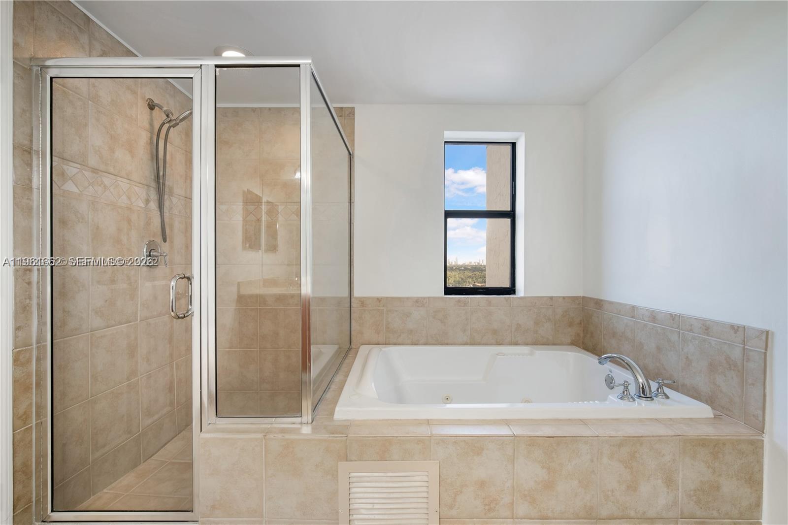888 Douglas Road, Unit 1401 Coral Gables, FL 33134 - Photo 4 of 43 a bathroom with a bathtub and shower