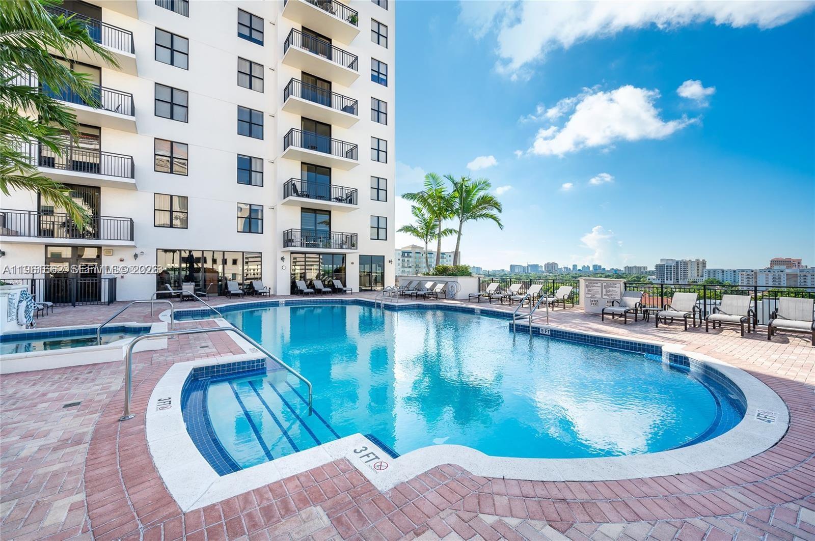 888 Douglas Road, Unit 1401 Coral Gables, FL 33134 - Photo 41 of 43 a view of a swimming pool with lounge chair