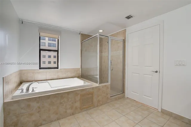 a bathroom with a bathtub and shower