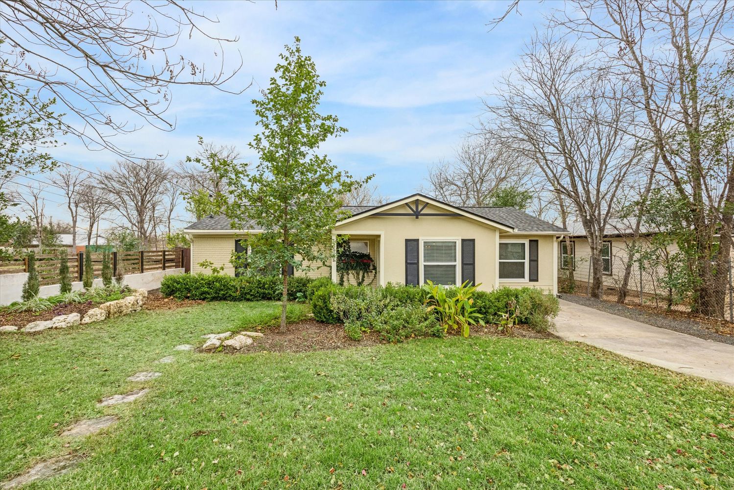 a front view of house with yard and green space