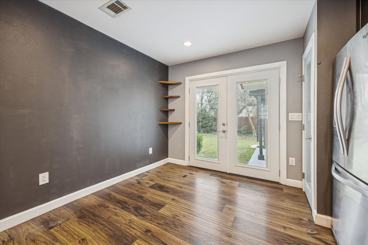 2921 Pecan Springs Road Austin, TX 78723 - Photo 13 of 21 a view of empty room with wooden floor and fan