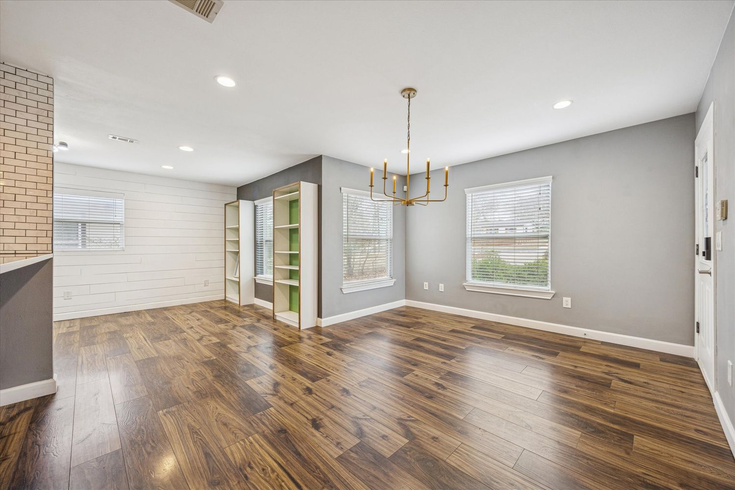 2921 Pecan Springs Road Austin, TX 78723 - Photo 6 of 21 a view of empty room with wooden floor and window