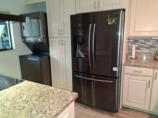 a kitchen with a refrigerator and cabinets