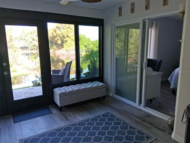 a view of a room with wooden floor and windows