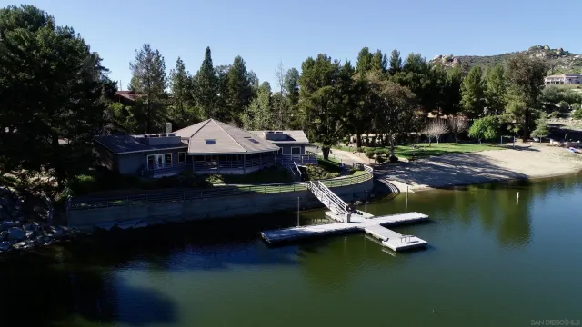 a swimming pool with outdoor seating and trees
