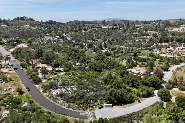 an aerial view of a residential houses with city view