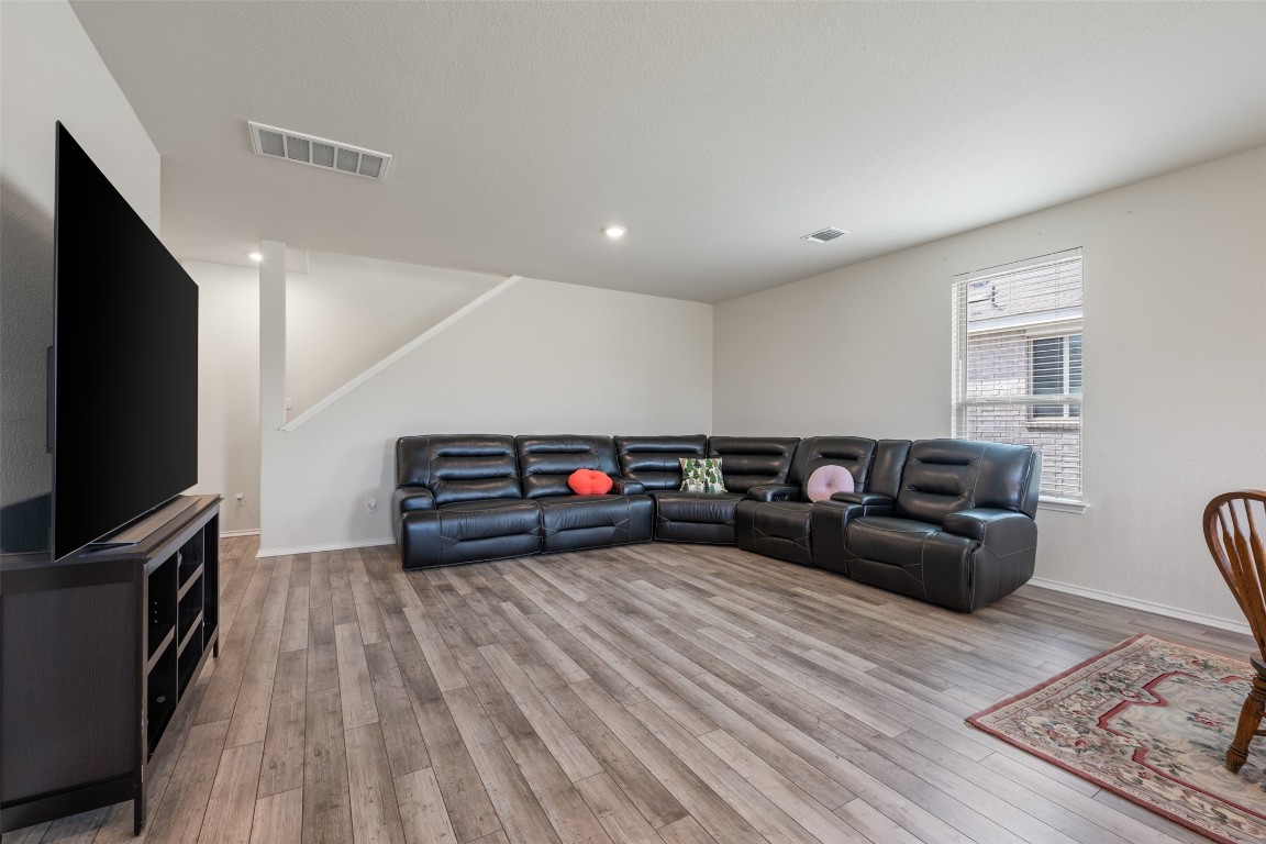 225 Gunther Way Taylor, TX 76574 - Photo 11 of 40 a living room with furniture and a flat screen tv