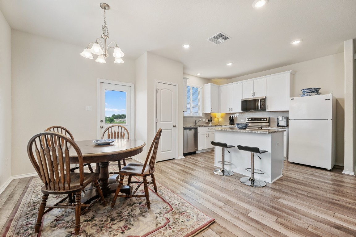 225 Gunther Way Taylor, TX 76574 - Photo 15 of 40 a view of kitchen with refrigerator a dining table and chairs