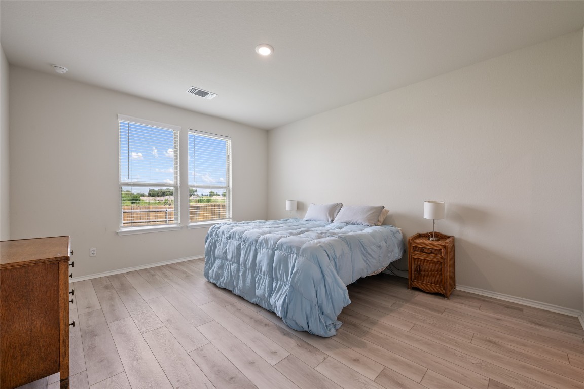 225 Gunther Way Taylor, TX 76574 - Photo 20 of 40 a bedroom with a bed and a window