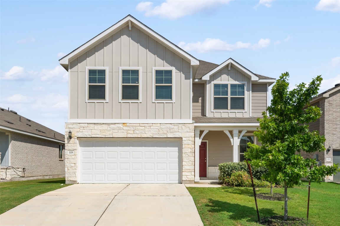 225 Gunther Way Taylor, TX 76574 - Photo 2 of 40 a front view of a house with a yard and garage