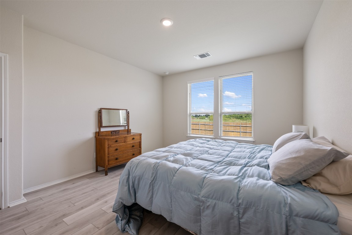 225 Gunther Way Taylor, TX 76574 - Photo 21 of 40 a bedroom with a bed and a closet