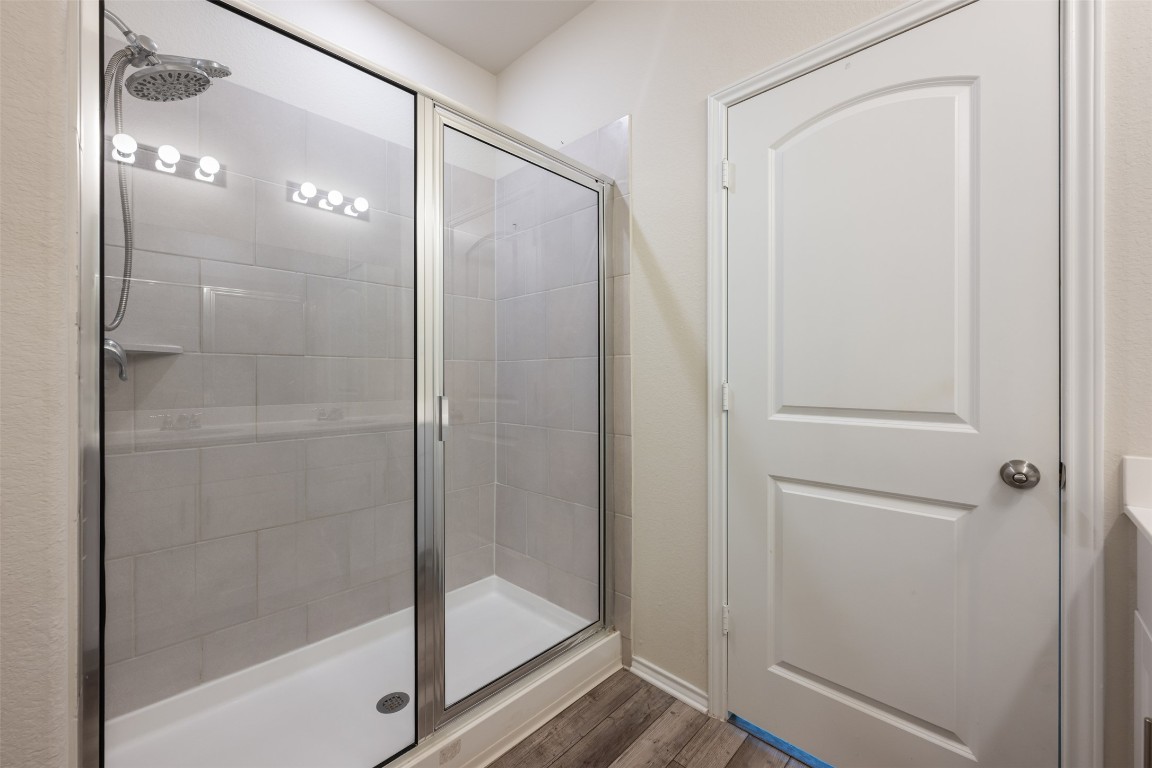 225 Gunther Way Taylor, TX 76574 - Photo 25 of 40 a bathroom with a glass shower door