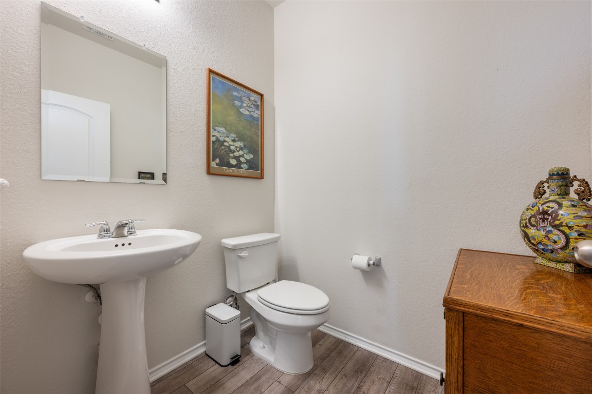 225 Gunther Way Taylor, TX 76574 - Photo 26 of 40 a bathroom with a sink mirror and toilet
