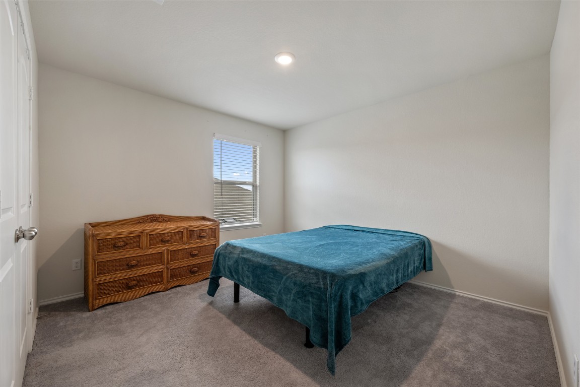 225 Gunther Way Taylor, TX 76574 - Photo 32 of 40 a bedroom with a bed and a dresser