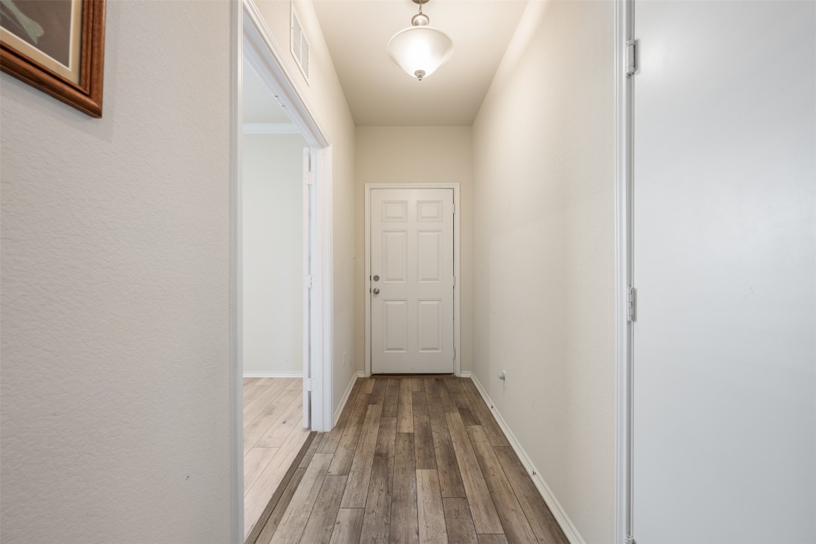 225 Gunther Way Taylor, TX 76574 - Photo 4 of 40 a view of a hallway with wooden floor