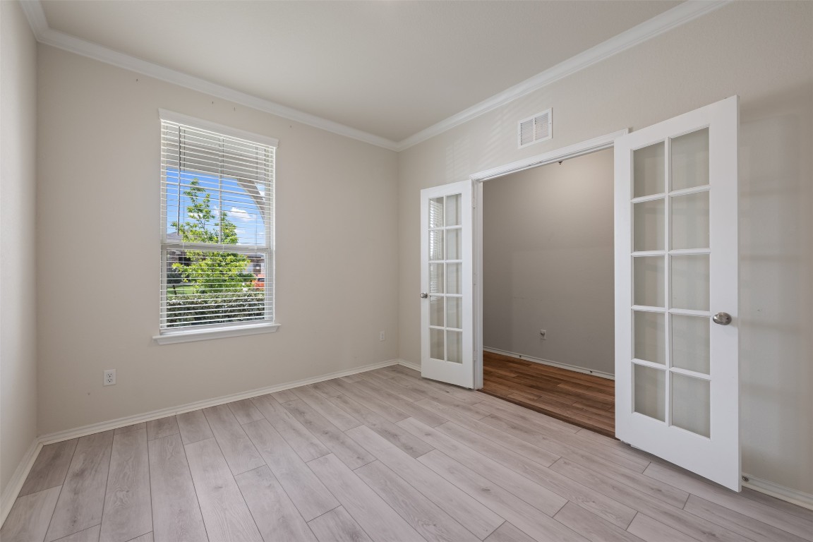 225 Gunther Way Taylor, TX 76574 - Photo 7 of 40 an empty room with wooden floor and window