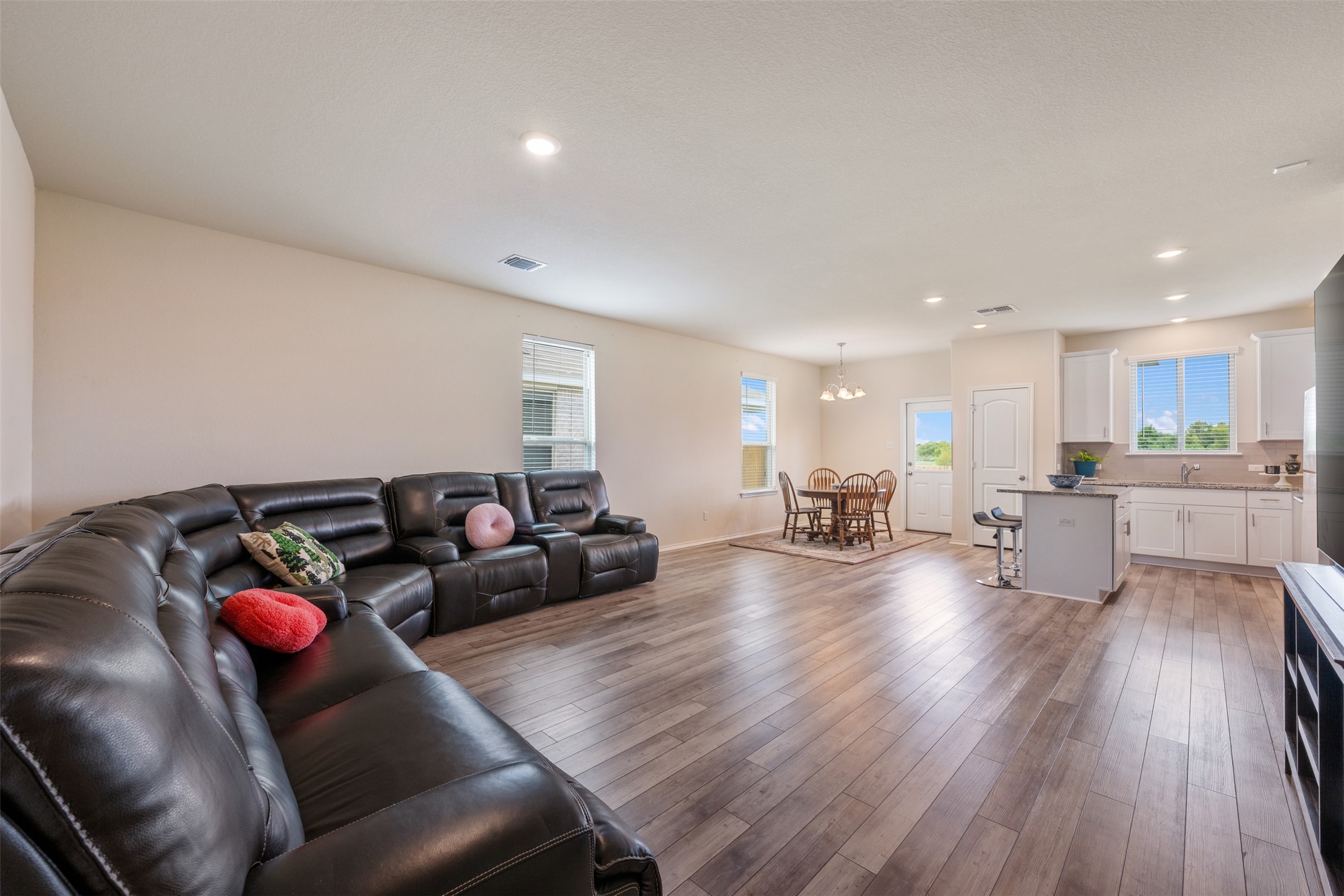 225 Gunther Way Taylor, TX 76574 - Photo 8 of 40 a living room with furniture and wooden floor