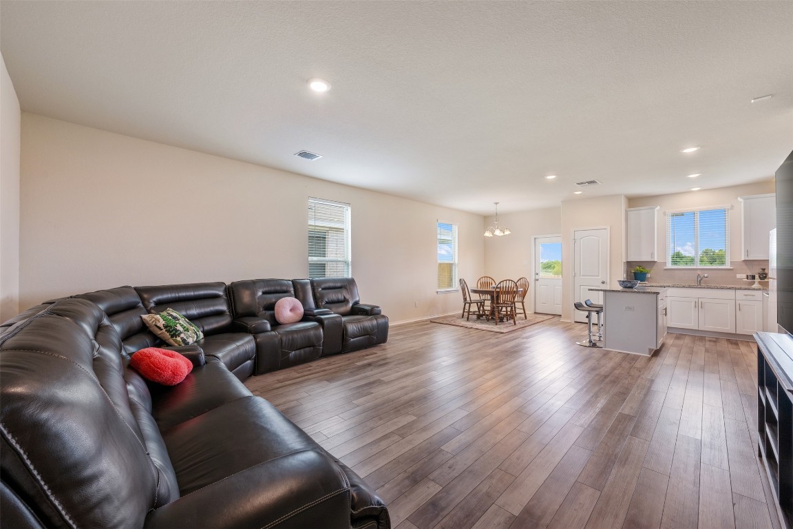 225 Gunther Way Taylor, TX 76574 - Photo 8 of 40 a living room with furniture and wooden floor