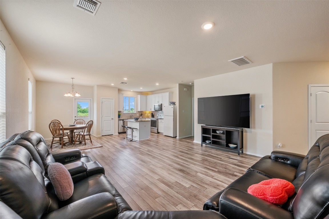 225 Gunther Way Taylor, TX 76574 - Photo 9 of 40 a living room with furniture and a flat screen tv