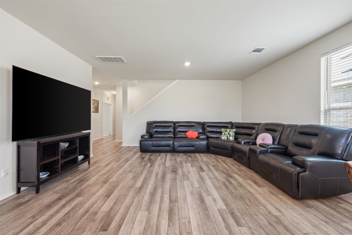 225 Gunther Way Taylor, TX 76574 - Photo 10 of 40 a living room with furniture and a flat screen tv