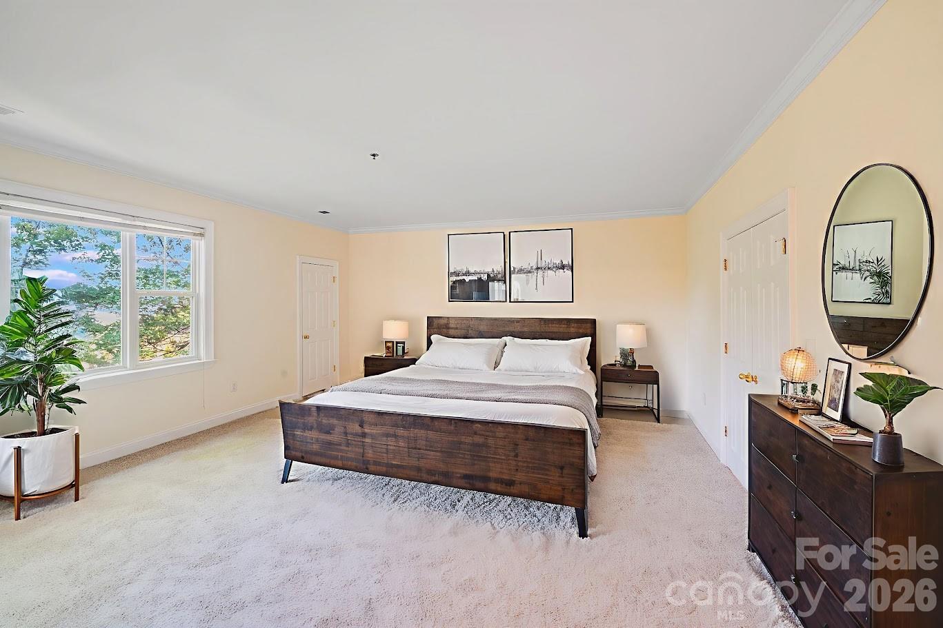 5601 Fairview Road, Unit 10 Charlotte, NC 28209 - Photo 15 of 28 a spacious bedroom with a bed a dresser next to a window