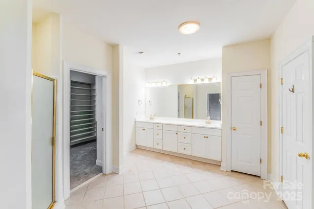 a large bathroom with a shower and a sink