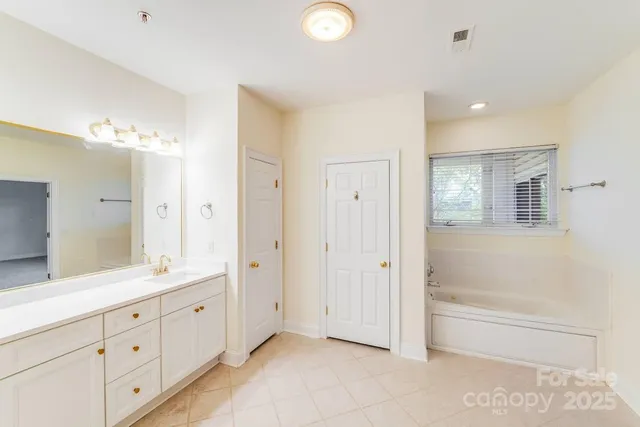 a spacious bathroom with a mirror a double vanity sink and a mirror