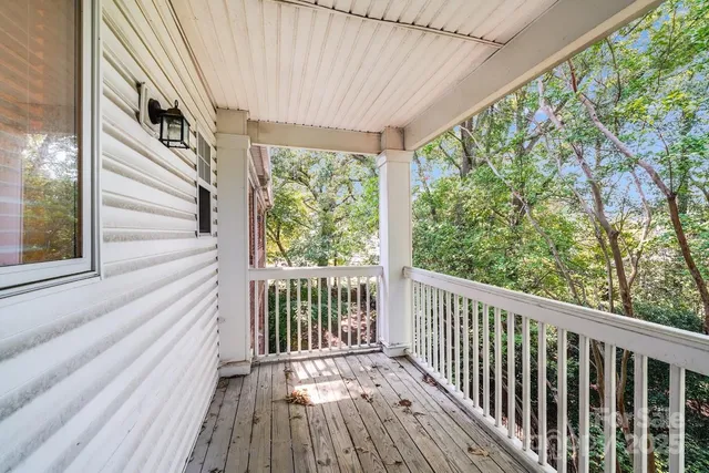 a view of balcony with wooden floor