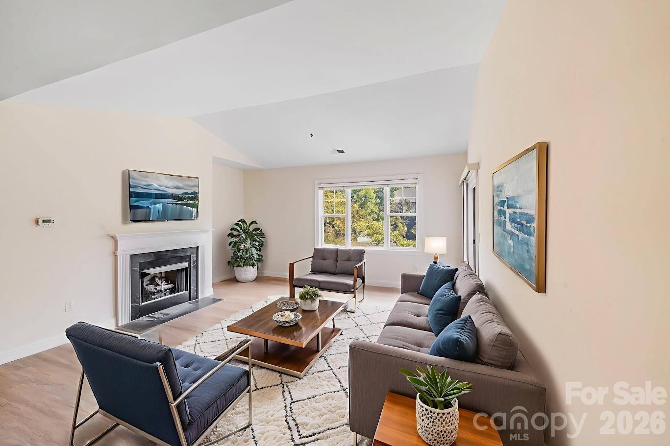 5601 Fairview Road, Unit 10 Charlotte, NC 28209 - Photo 3 of 28 a living room with furniture a fireplace and a large window