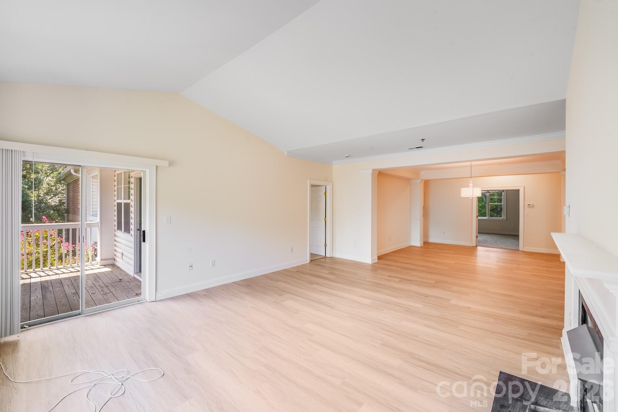 5601 Fairview Road, Unit 10 Charlotte, NC 28209 - Photo 9 of 28 a view of an empty room with wooden floor and a window