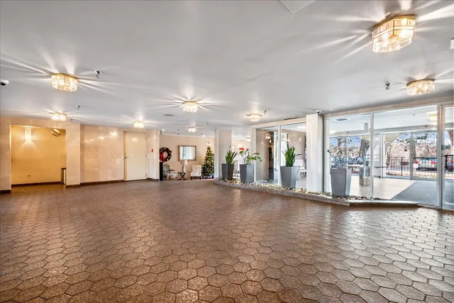a living room with furniture and flowers