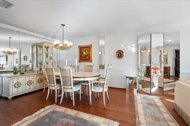 a kitchen with stainless steel appliances granite countertop a refrigerator a sink dishwasher and a refrigerator with wooden floor