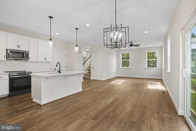 a view of a kitchen with a sink and microwave