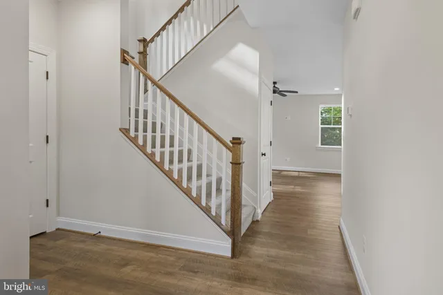 a view of a hallway with wooden floor and entryway
