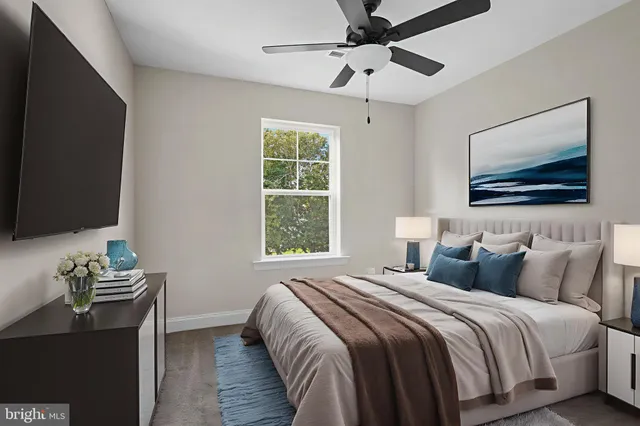 a bedroom with bed tv and window